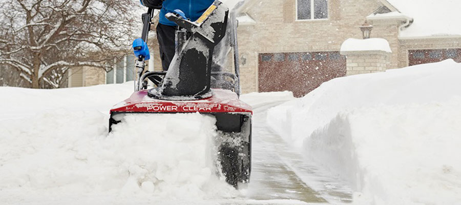 Snow blower clearing a driveway from Uxbridge Mower